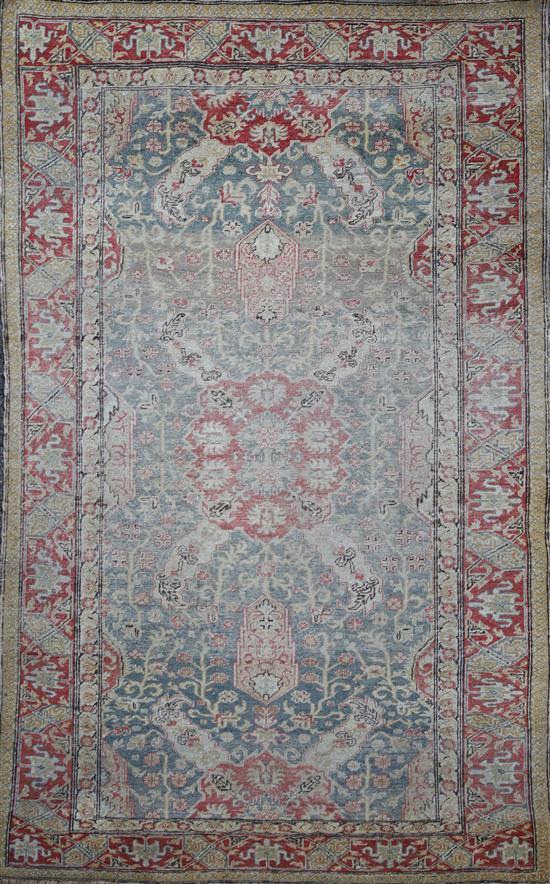A Turkish blue ground rug, 6ft 5in by 4ft 5in.